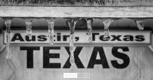 sign that says "Austin, Texas" that has icicles on it.